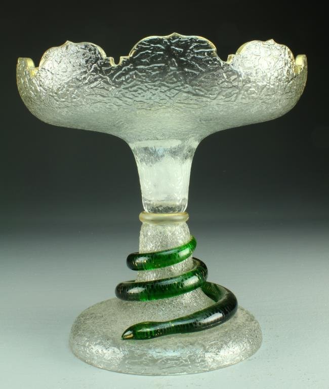 A Large Antique Glass and Gilt Compote: Comprised of clear crinkle glass and having shaped rim with gilt decoration, raised on circular stem with coiled green glass and gilt decorated snake, measures 9.5"h, circa late 19th-early 20th centur