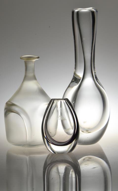 (3) Kosta Boda Art Glass Vases: To include a frosted glass bottle form example, artist signed B. Vallien, two clear glass examples both of organic form and both signed to the underside, tallest is 8.75"H, circa 20th century.