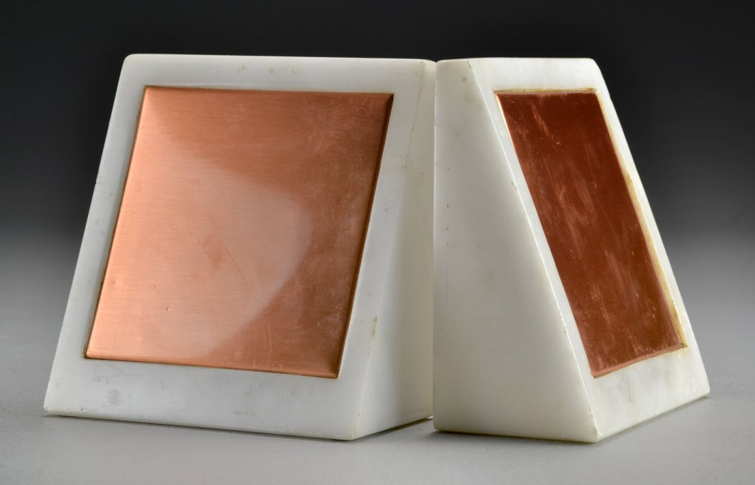 Pr. Raymor Italian Marble and Copper Bookends: Of modernistic design, both in triangular form with copper inserts, inscribed to base "Italy, Raymor, 86, XII", measures 5.25"H, circa 20th century. Condition, bookends having several knicks to edges.