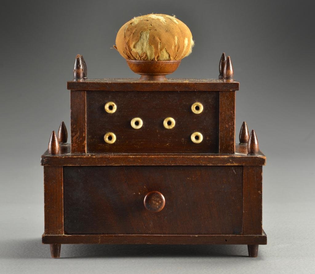 19th c. American Walnut Two-Tier Sewing Box: Having eight thread post finials, a single pin cushion mounted on a removaable lid which lifts to reveal six metal thread posts, the first tier having ivory or bone thread eyelets above a single drawe