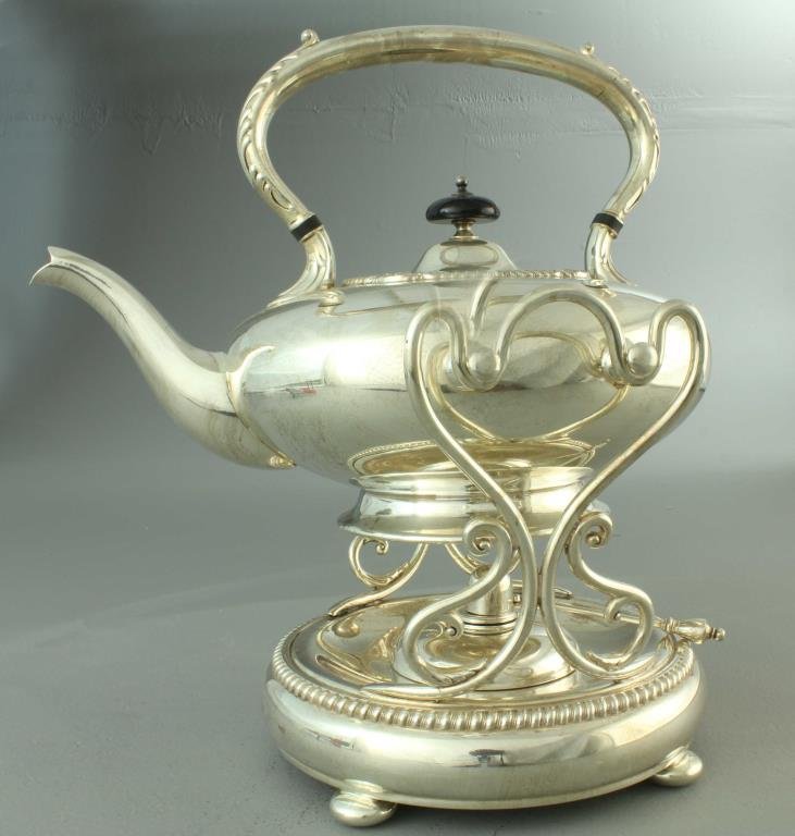 Antique E.G. Webster & Son Hot Water Kettle and Stand: A plated example having decorative handle with turned wood finial, pierced sides, circular base with beading and bun feet, marked to underside of kettle with lion, crown, other various hallmarks, and 