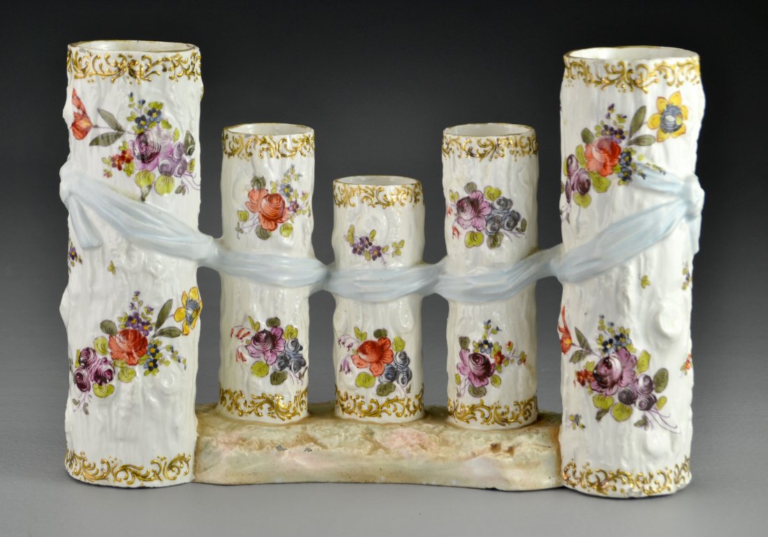 Antique Continental Hand Painted Porcelain Trunk Vase: Having five graduated vessels formed as tree trunks with hand painted flower bouquets and raised gilt scroll decoration, probably Austrian, measures 7.25"H x 10"L, circa 19th century. Condition, havin