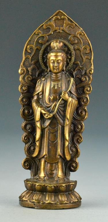Chinese Bronze Figure Of Guanyin: Finely molded to depict Guanyin standing atop a double lotus base holding a ruyi scepter, 7"H. Property of a Traverse City Michigan Gentleman.