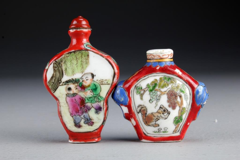 (2) Chinese Famille Rose Porcelain Snuff Bottles: One having beast head handles and painted at center to depict squirrel with grapes and hedgehog with pumpkin, the other depicting youth in landscape scenes, tallest is 2.9"H.