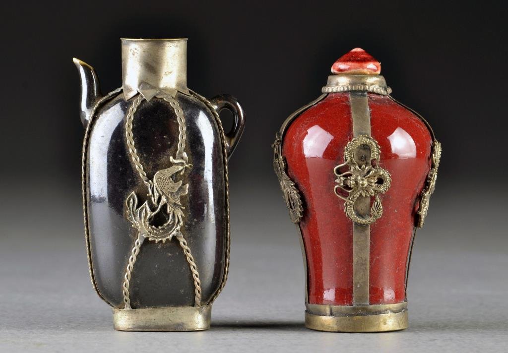 (2) Chinese Porcelain Snuff Bottles: One formed as teapot, each having metal encasements with depictions of four clawed dragons, beast heads and phoenix, one base stamped with two character mark, tallest is 3.25"H.