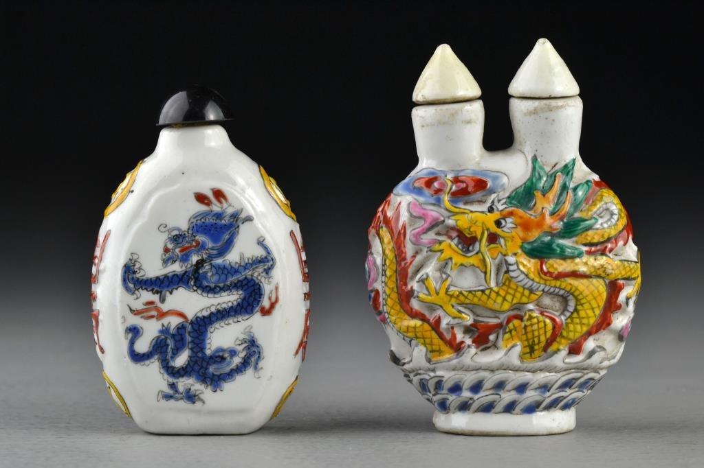 (2) Chinese Porcelain Snuff Bottles: To include a double necked example with a molded and painted surface depicting four clawed dragons among ruyi clouds, the second example painted with dragons, coins and Shou symbols to sides, tallest