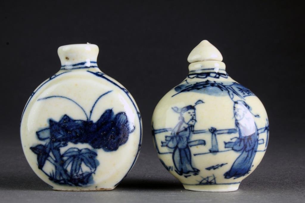 (2) Chinese Blue and White Porcelain Snuff Bottles: Two small blue and white porcelain examples, finely painted at center to depict cricket, bunches of grapes and figures in a landscape, bases marked by blue leaf underglaze, tallest is 2.1"H.