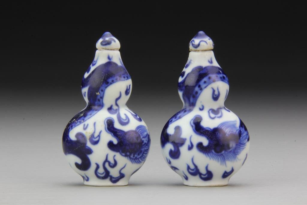 (2) Chinese Blue and White Porcelain Snuff Bottles: Formed as gourds and painted in similar depiction of three clawed dragon, bases have leaf in underglaze blue, tallest is 2.9"H. From the collection of David Bell who worked for an Italian steel compan