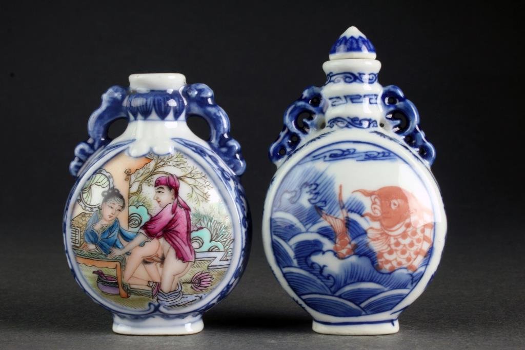 (2) Chinese Blue and White Porcelain Snuff Bottles: Formed as moonflasks, one finely painted at center to depict couple in erotic scene with calligraphy and red seals to reverse and a scrolling floral border, the second example depicting koi fish atop