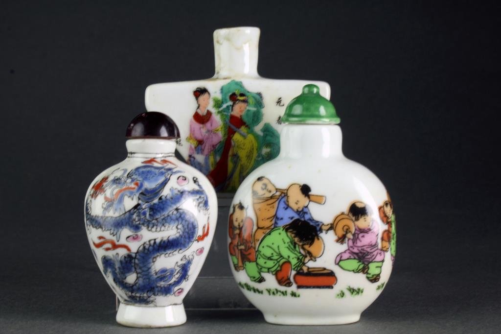 (3) Chinese Famille Rose Porcelain Snuff Bottles: One depicting playful youth in a landscape with base marked by a blue leaf underglaze, one of triangular form depicting beauties and having character marks, other depicting five clawed dragon and flam