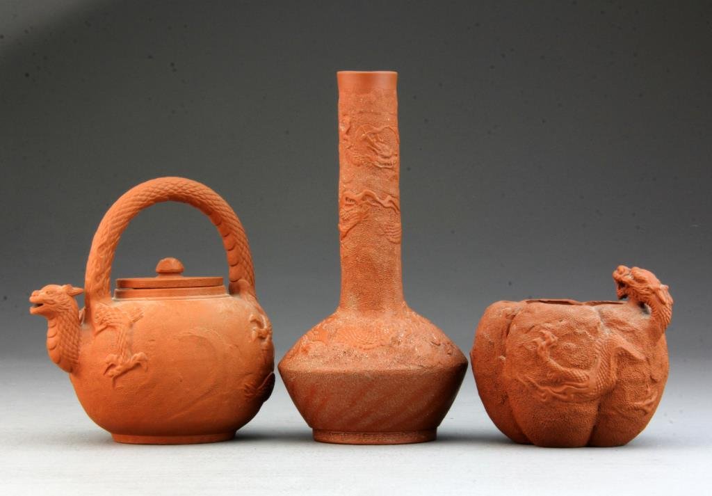 (3) Pcs. Chinese Yixing Pottery: To include bottle-form vase finely molded to depict three clawed dragons, base bearing character marks, gourd shaped pot molded with dragon, and teapot, handle and spout finely formed as scaled dragon