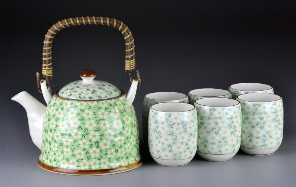 (7) Piece Chinese Contemporary Porcelain Tea Set: Depicitng cheery blossoms, having a tea pot and six cups, teapot measures 5"H X 6.75"L.