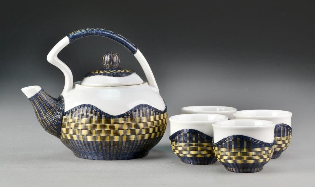 (5) Piece Chinese Wicker Over Porcelain Tea Set: To include a teapot and four cups, pot measures 4.5"H X 5.5"L.