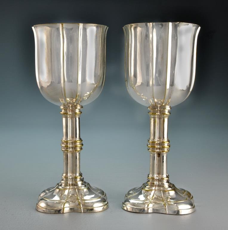 A Pair of Antique Silver Plated Chalices: Having scalloped rim and paneled bowl, interior gold washed and the stem column formed, having a stepped scalloped base, apparently unmarked, no monogram, measure 9"H, circa late 19th-early 20th centu