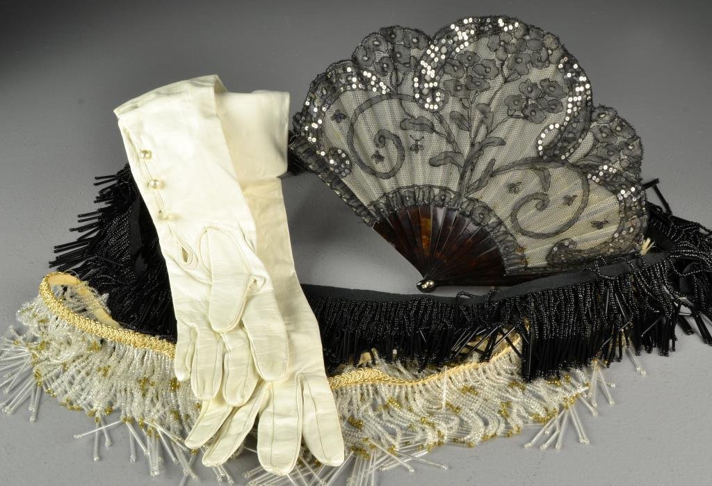 (4) Pcs Women's Couture Articles: To include a pair of opera length kid-leather gloves with silk lining, size 6.5, a French lace, sequin and faux-tortoise shell fan, and two strings of beaded fringe, longest fringe measures approx. 78