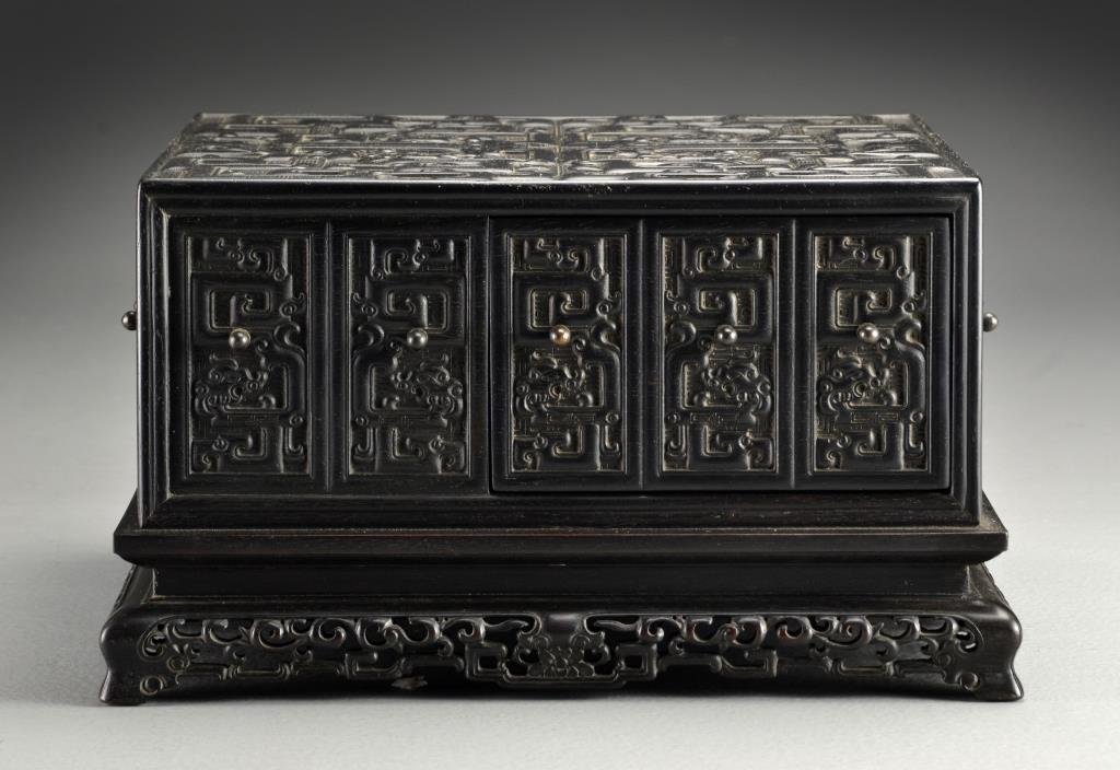 A Fine Chinese Zitan Wood Snuff Box: Having four drawers and four faux drawers, intricately carved with dragons, raised on four finely shaped feet and carved open work base, having four character inscription to base, 6"H X 10.5"W X 10.5"
