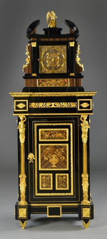A Gilt Bronze & Ebony Wood Cabinet & Matching Clock: In the neoclassical taste the cabinet having one door opening to a shelved interior, having finely cast gilt bronze mounts depicting classical maidens, rosettes, floral and floral and scroll, the door