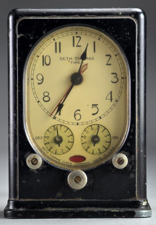 A Seth Thomas Industrial Clock: Labeled Seth Thomas Timer having three dials in black metal case, appears to be in working order, 6"H, circa early 20th century.