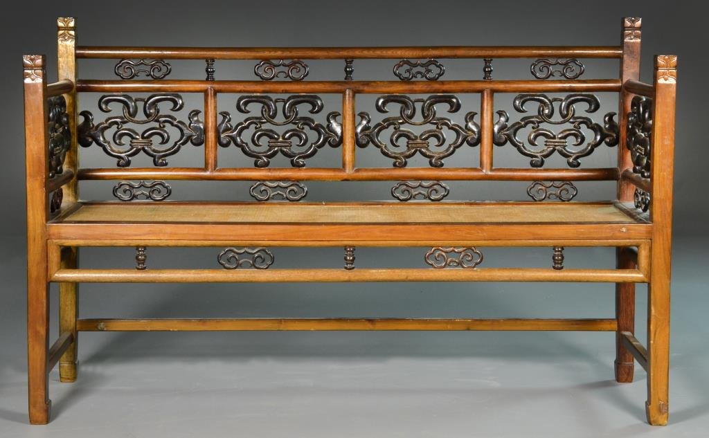 Chinese Qing Hardwood Bench: Having open work carved elements throughout, a rattan seat, very well done, 39"H x 61"W x 18.5"D, circa late 19th-early20th century. Condition, with repaired carving to back splat.