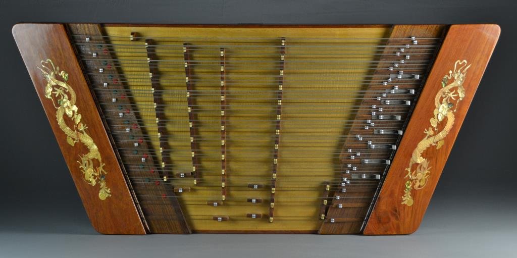 A Fine Chinese Yangquin Musical Instrument: Of various woods and inlaid with stained MOP, with makers label attached to front, in fitted case with keys, wooden sticks and adjusting tool, instrument measures 46"W x 20.5"D, circa 1960's.