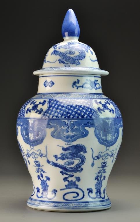 Chinese Blue & White Porcelain Covered Urn: Depicting four clawed dragons and phoenix among various antiques and lotus flowers, underside stamped with blue seal mark within concentric squares underglaze, measures 18.5"H, circa 20th century. Ove