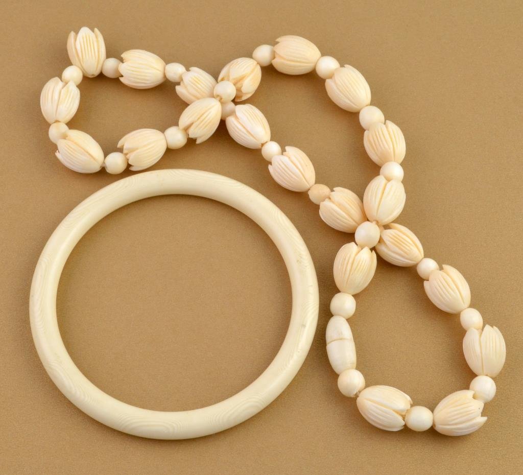 (2) Pieces Ivory Jewelry: To include a necklace having carved rosettes and circular bead spacers, 18"L together with an ivory bangle having a polished surface, 3.25"D, both circa early to mid-20th century.