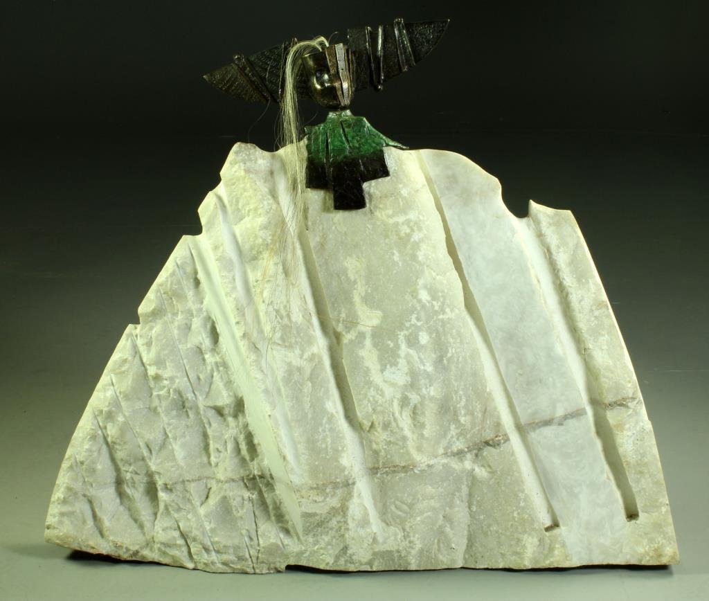 A Massive Signed Mayan Bronze & Carved Marble Sculpture: Comprised of a finely patinaed bronze figure having horse hair decoration and inscribed in Spanish to the back, mounted on a large carved white marble slab, the bronze in the Mayan taste, consignor pa