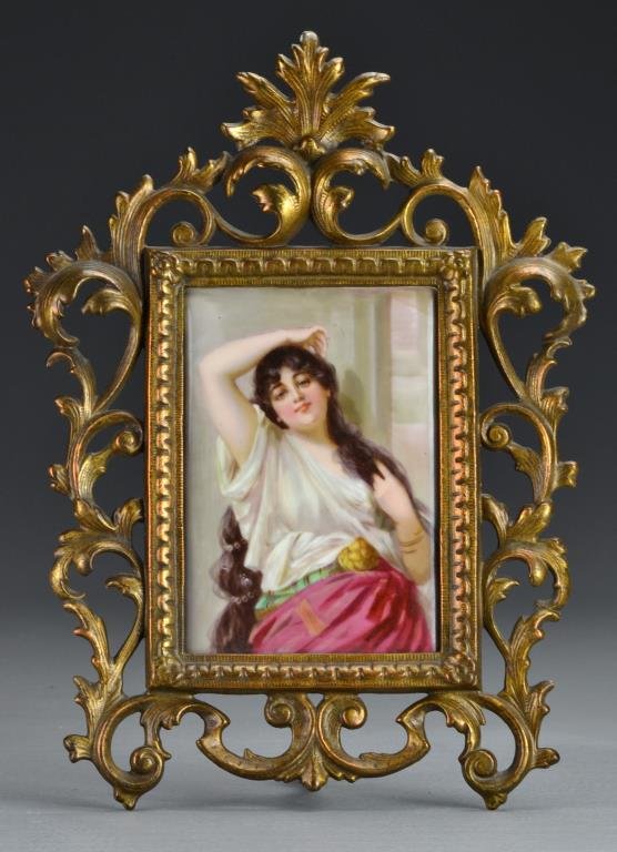 KPM Style Porcelain Plaque: Finely painted to depict a beauty, marked with the numbers 107 en verso, resting in an art deco bronze frame, palque measures 5.5"H X 3.75"W, 11.75"H X 8.5"W framed, circa late 19th/early 20th century