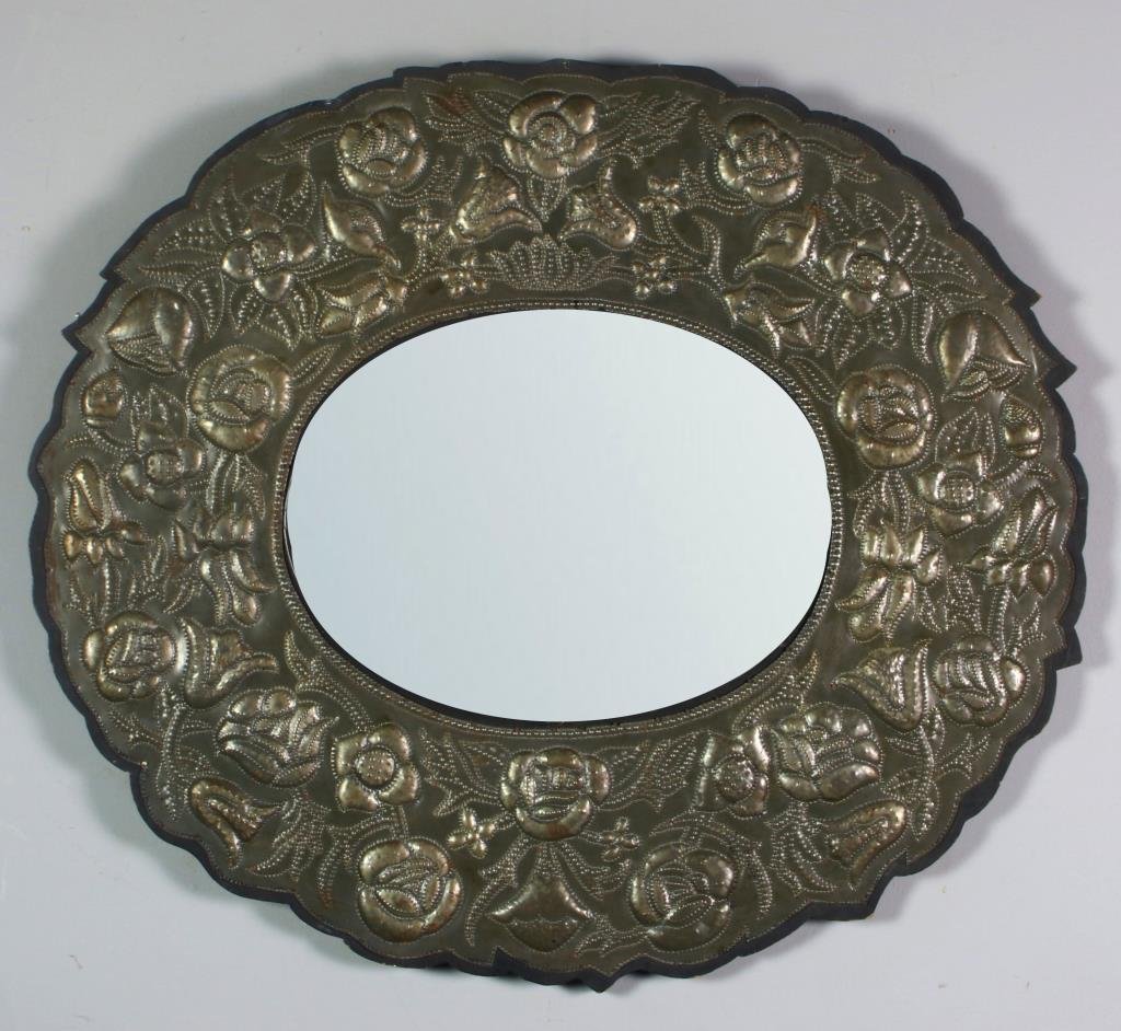 Civil War Era Punched Tin Mirror: Of ovular form, having tin border punched with floral design, tin mounted on wood frame, measures 27.5"H x 31.25"W, tin circa mid-late 19th century, glass has been replaced. Condition: with normal wea