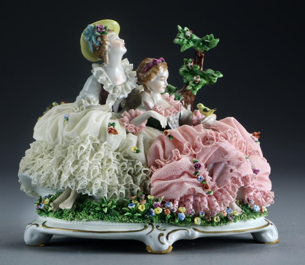 Unterweissbach German Porcelain Figural Group: Depicting two women in a garden, having elaborate lace elements, raised on scrolled base with gilt highlights, underside with blue mark for Unterweissbach dating this piece to 1958-76, impressed "8289