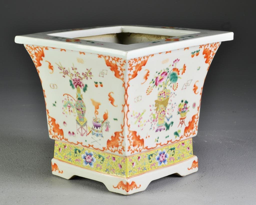 Chinese Famille Rose Porcelain Planter: Finely painted to depict various Buddhist symbols, having iron red border with bats at each corner, with four bracket feet, 8"H X 8.5"sq, possibly Republic.