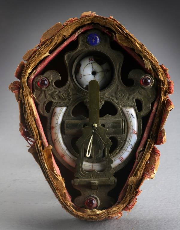 Antique Chinese Sundial In Original Box: Having porcelain numbers and perhaps a compass resting in a metal mount, the metal mount depicting flowers, having inset red glass beads and a blue bead with Chinese character, all set in it's origina