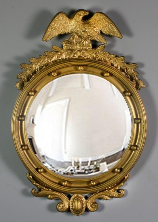 Federal Style Gilt Wood Bull's Eye Mirror: Having a carved gilt wood eagle crest with raised beading to frame, convex mirror, measures circa early 20th century. Condition: with normal wear and minor areas of loss to frame. Property of a Lapeer
