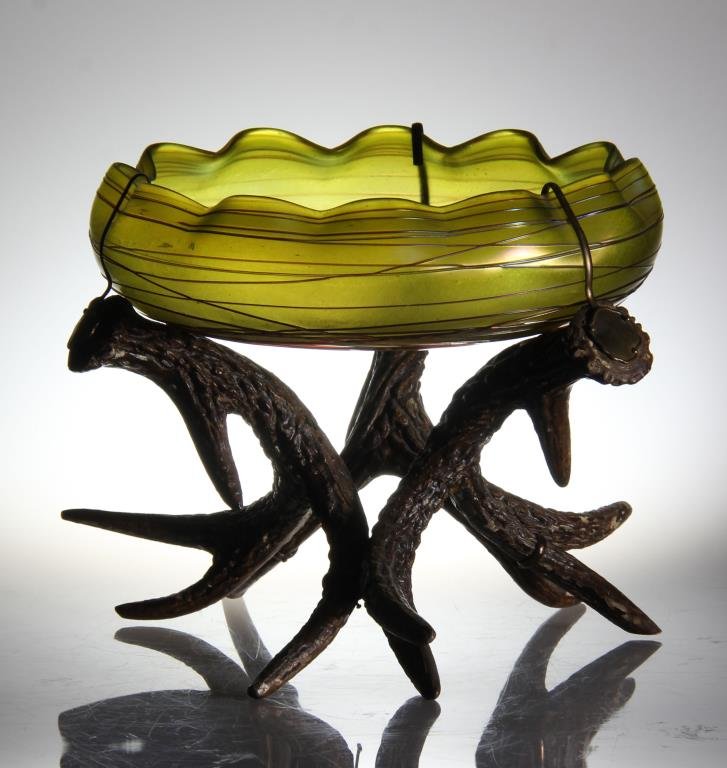 A Loetz Irridescent and Threaded Glass Bowl on Stand: Having a ruffled rim now mounted on an antler stand, apparently unsigned, bowl measures 8.25"D, overall measures 7"H, circa early 20th century. Property of a Washington, MI family.