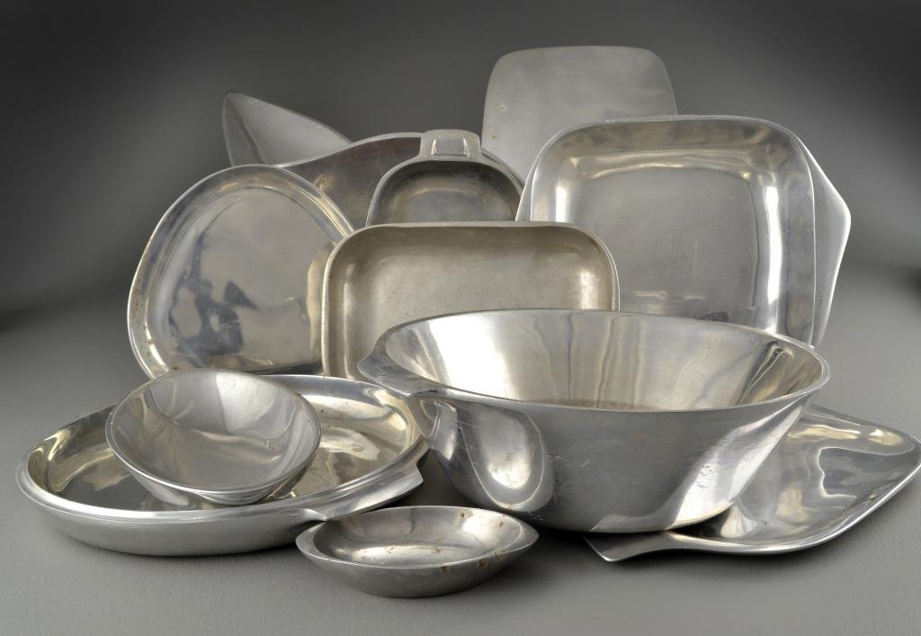 (43) Pcs Nambe Table Wares: A large assortment of Nambe table articles, including serving bowls, trays and utensils, Nambe alloy, circa 20th century. Condition: all with wear, in need of polishing.