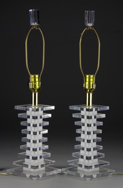 Pr. Karl Springer Designed Lucite Lamps: Fashioned from various sized lucite discs with frosted lucite spacers, each with lucite finial, measure 24"H, circa mid 20th century. We do not guarantee the working order of lamps at time of sale. Pr