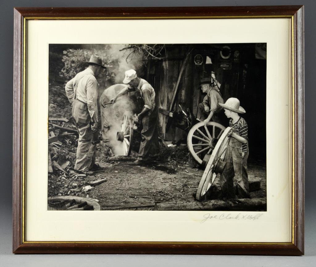 Joe Clark Signed Jack Daniels Photograph: A black and white photograph depicting figures at work in a country setting, matting pencil signed "Joe Clark, H.B.S.S.", Joe Clark and his wife Junebug Clark were the photographers for the iconic Jac