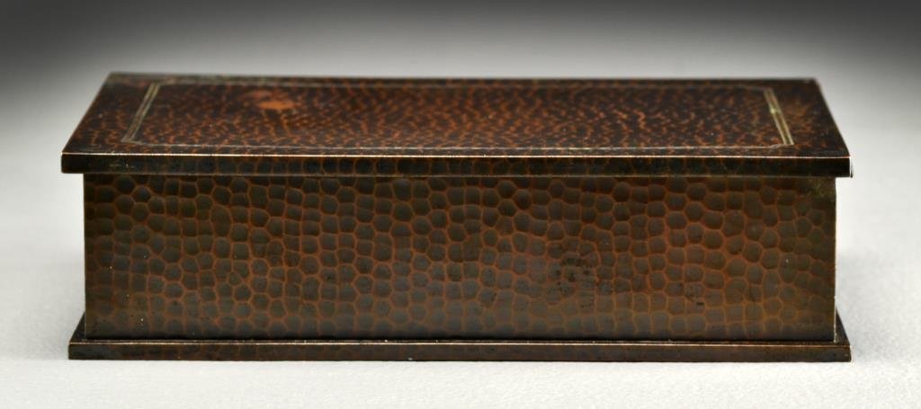 Roycroft Copper Humidor: Hand hammered with incised trim to top, having a lift top with original liner, underside marked with orb and cross Roycroft mark, measures 2.5"H x 9.5"L x 6.25"D, circa early 20th century, some surfac