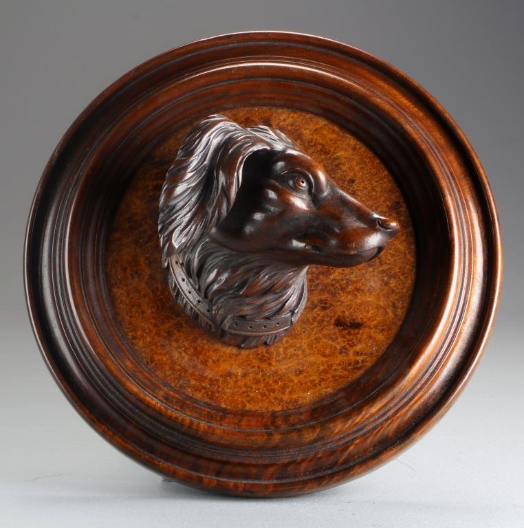 A Carved Black Forest & Burlwood Figural Plaque: A three dimensional carved Black Forest bust of a dog, mounted on a burlwood plaque with carved wood frame, measures 12"Dia., approximately 4"D., circa 20th century.