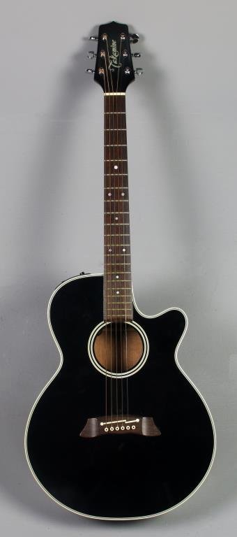 Takamine Electric Acoustic Guitar: A solid cedar top with mahogany back and sides and a rosewood fingerboard, having a Graph-Ex Preamp, numbered EF261SBL to interior, complete with a soft case, measures 40"L, circa late 20th century.