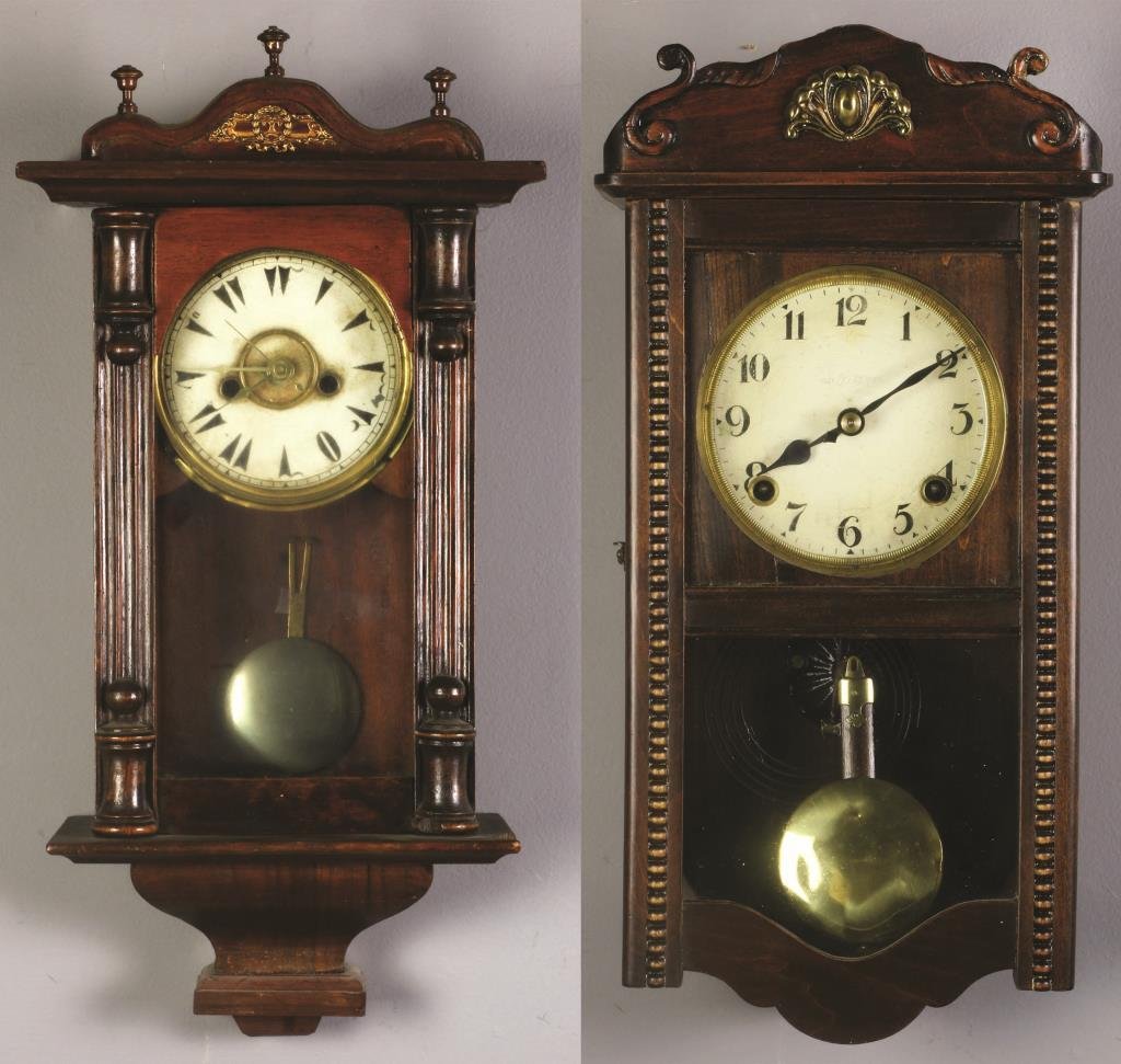 (2) English or Continental Carved Wood Wall Clocks: Each having carved elements, one with porcelain dial, decorated with beaded and columnar elements, largest measures 19"H, circa early 20th century. Property of a Lapeer, MI couple.