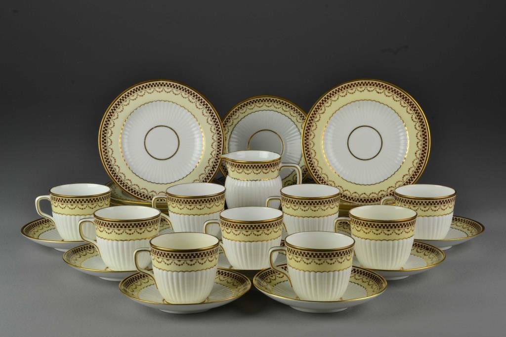 (32) Pieces Mintons English Gilt Porcelain Partial Tea: To include nine cups, twelve saucers, ten dessert plates and a creamer, all having ribbed surfaces and finely decorated gilt banding and highlights, all stamped "Minton", largest measures 6.25"D, circ