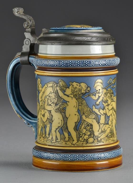 A Mettlach Stoneware Stein, Villeroy & Boch: Stamped Mettlach and further stamped Gegen Nachbildung Geschutzt, design 2025, additionally numbered 91 and 33, the stein depicting Dionysus and figures indulging and celebrating, pewter rim inscribed