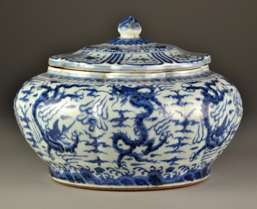 Large Chinese Blue & White Porcelain Covered Urn: The lobed body painted to depict five clawed dragons amongst ruyi clouds contesting flaming pearls, the lid decorated with Buddhist symbols, six character marked to body, 9.25"H.