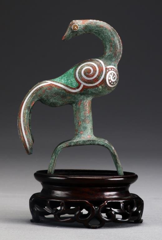 Chinese Shang Style Bronze Finial: Depicting a peacock with silver inlay, now raised on a later hardwood stand, bronze measures 6"H without stand, circa possibly 19th century. Property of a private Michigan collector who collected thes