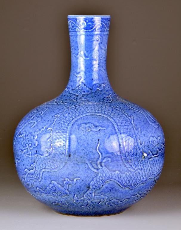 Large & Fine Chinese Porcelain Vase: having an all over blue glaze, depicting a dragon amongst ruyi clouds in low relief, having six character mark to neck of vase, 16"H.