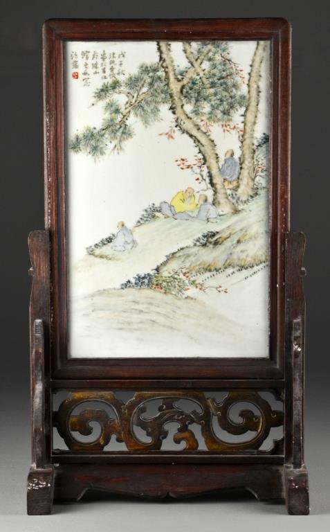 Chinese Famille Rose Porcelain Table Screen: Finely painted to depict figures under an ancient tree, having several lines of calligraphy and red seal upper left, porcelain measures 14.75"H X 9.5"W, overall measures 22.75"H X 13"W, possibly Repub