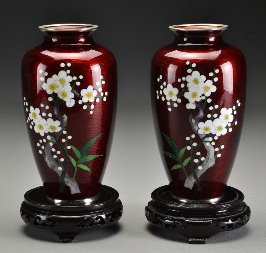Pr. Japanese Cloisonné Ginbari Vases: Having cherry blossom decoration to one side against a smooth deep red ground, measure 7.25"H, circa 20th century. Property of a Birmingham, MI family.