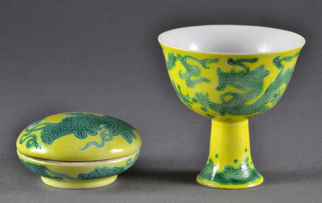 (2) Chinese Green & Yellow Porcelain Articles: To include a covered dish decorated with grape vines, underside bearing six character mark within two concentric circles in underglaze blue, along with a footed cup depicting five clawed dragons chasi