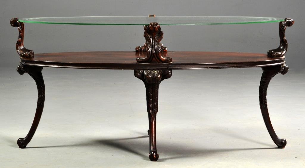 Carved Wood & Etched Glass Two-Tiered Coffee Table: Having an etched glass top supported by four scrolled acanthus leaves, raised on splayed legs with paw feet, measures approximately 19"H x 40"L x 22.5"D, circa early 20th century. Condition: light ove
